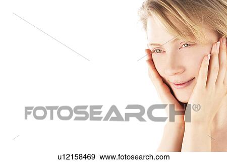 Stock Photo - Young woman with hand on chin. Fotosearch