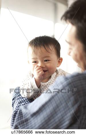 Stock Photograph - Baby Boy and Father. Fotosearch