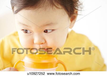 Stock Image - Baby Boy Drinking. Fotosearch