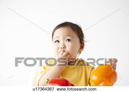 Stock Photo - Baby Boy Eating Bell Pepper. Fotosearch