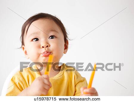Stock Photography - Baby Boy Eating Vegetable. Fotosearch
