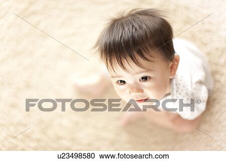 Stock Image - Baby Boy Sitting on Floor. Fotosearch