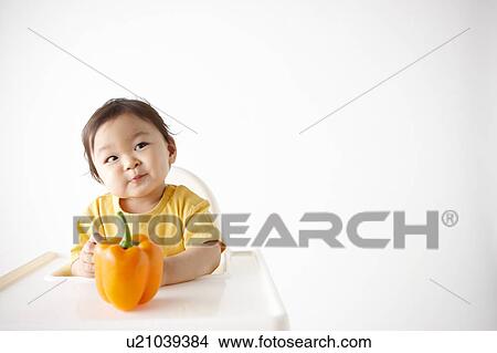 Picture - Baby Boy with Bell Pepper. Fotosearch