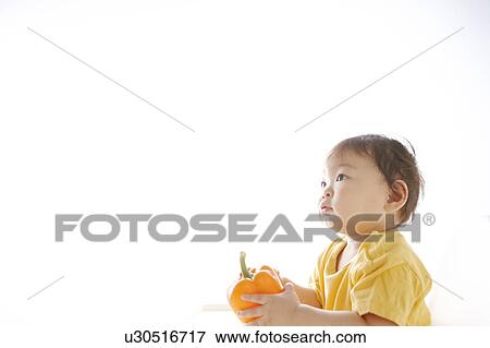 Stock Photo - Baby Boy with Bell Pepper. Fotosearch