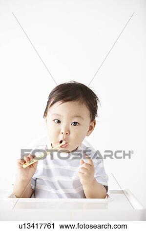 Stock Image - Baby Brushing Teeth. Fotosearch