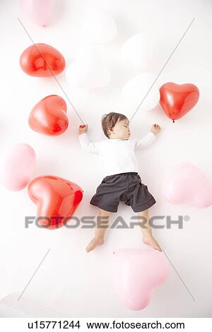 Picture - Baby in Midst of Balloons. Fotosearch