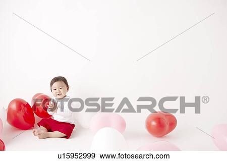 Baby in Midst of Balloons View Large Photo Image Stock Photo - Baby in Midst of Balloons. Fotosearch