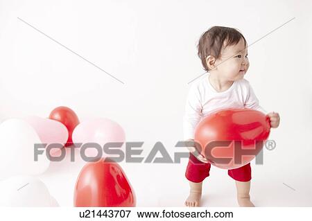 Baby in Midst of Balloons View Large Photo Image Stock Photo - Baby in Midst of Balloons. Fotosearch