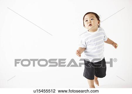 Stock Image - Baby Taking First Steps. Fotosearch