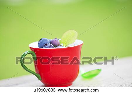 Stock Image - Blueberries in Red Cup. Fotosearch