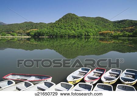 Stock Photo - Boats Moored at Lake. Fotosearch