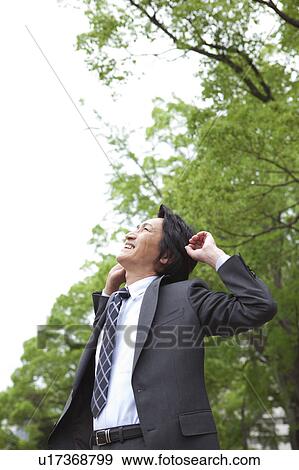 Businessman stretching outdoors View Large Photo Image Stock Photo - Businessman stretching outdoors. Fotosearch