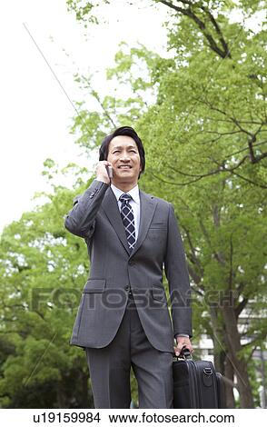 Businessman using cell phone View Large Photo Image Picture - Businessman using cell phone. Fotosearch