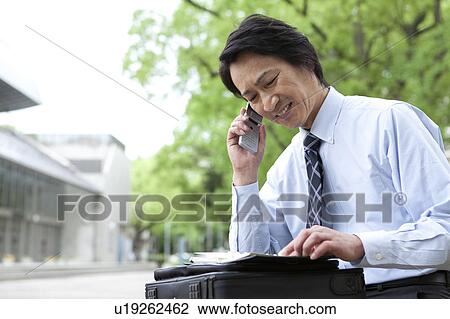 Businessman using cell phone View Large Photo Image Stock Image - Businessman using cell phone. Fotosearch