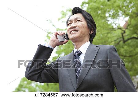 Businessman using cell phone View Large Photo Image Stock Photo - Businessman using cell phone. Fotosearch