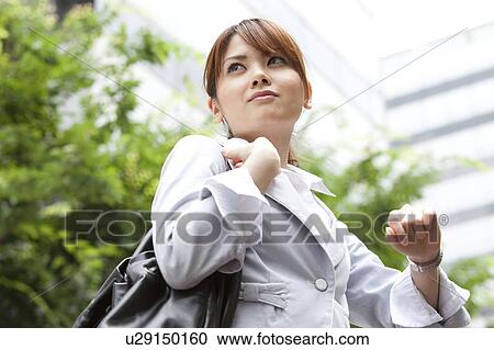 Businesswoman checking the time View Large Photo Image Stock Image - Businesswoman checking the time. Fotosearch