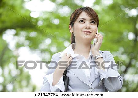 Picture - Businesswoman on cell phone. Fotosearch