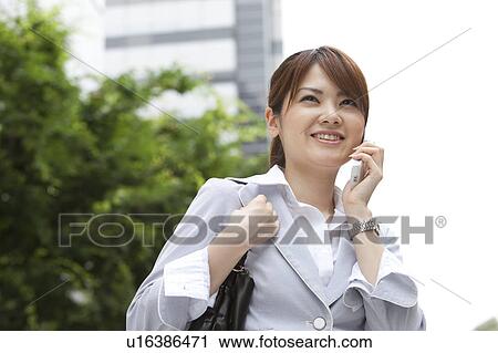 Stock Image - Businesswoman on cell phone. Fotosearch