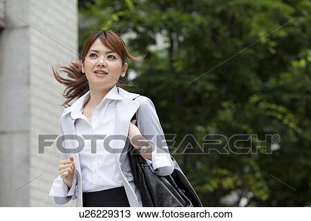 Stock Image - Businesswoman running. Fotosearch