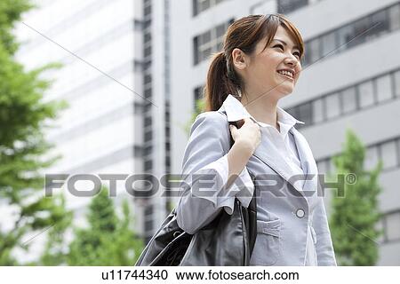 Businesswoman standing outdoors View Large Photo Image Stock Image - Businesswoman standing outdoors. Fotosearch