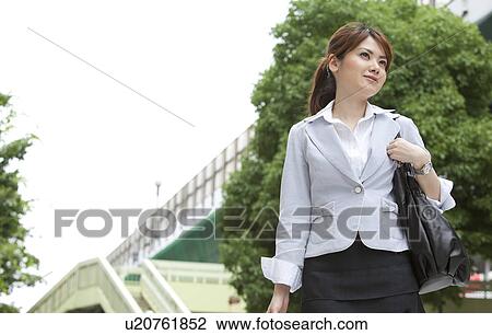 Businesswoman standing outdoors View Large Photo Image Stock Image - Businesswoman standing outdoors. Fotosearch
