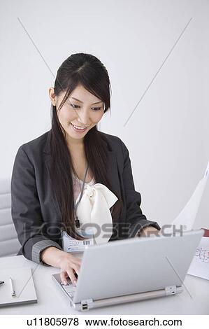 Stock Photo - Businesswoman using laptop. Fotosearch