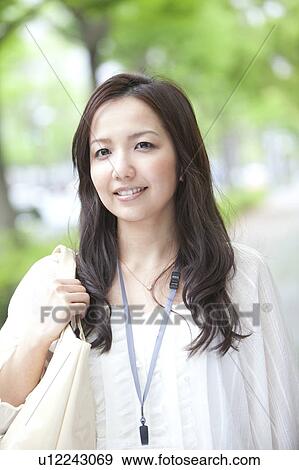 Stock Photo - Businesswoman walking outdoors. Fotosearch