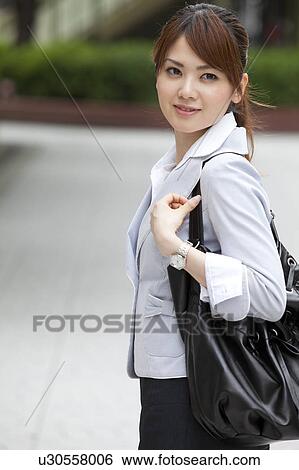 Stock Photograph - Businesswoman with shoulder bag. Fotosearch