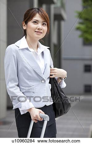 Picture - Businesswoman with suitcase. Fotosearch
