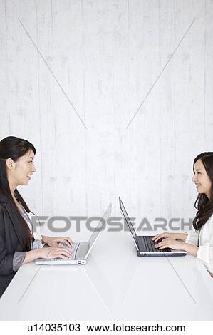 Stock Image - Businesswomen using laptop. Fotosearch