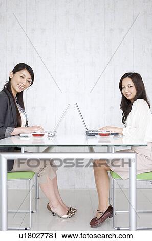 Businesswomen using laptop View Large Photo Image Stock Image - Businesswomen using laptop. Fotosearch