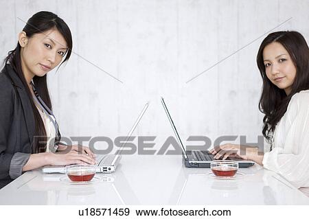 Businesswomen using laptop View Large Photo Image Stock Photo - Businesswomen using laptop. Fotosearch