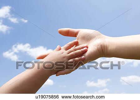 Stock Photograph - Child and Adult Holding Hands. Fotosearch