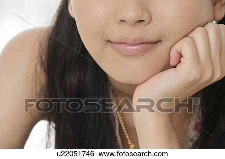 Close Up Of Young Woman Resting Chin on Her Hand View Large Photo Image Stock Photograph - Close Up Of Young Woman Resting Chin on Her Hand. Fotosearch