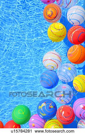 Stock Image - Colorful Balloons Floating on Water. Fotosearch