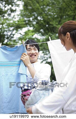 Couple hanging laundry View Large Photo Image Stock Image - Couple hanging laundry. Fotosearch