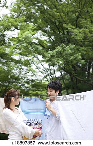 Stock Photo - Couple hanging laundry. Fotosearch