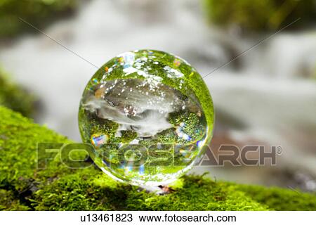 Stock Image - Crystal Ball on Moss. Fotosearch