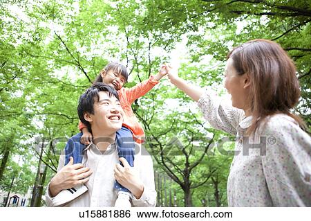 Daughter sitting on father's shoulders View Large Photo Image Stock Photograph - Daughter sitting on father's shoulders. Fotosearch