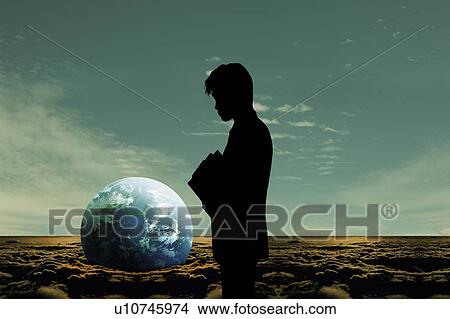 Picture - Earth in sand and silhouette of a man, Digital composite. Fotosearch