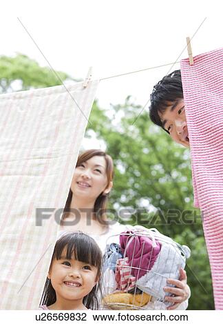 Family doing laundry View Large Photo Image Stock Image - Family doing laundry. Fotosearch