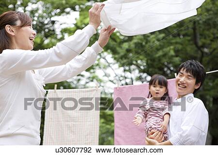 Stock Image - Family doing laundry. Fotosearch