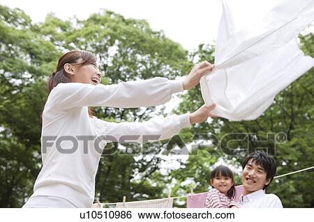 Family doing laundry View Large Photo Image Stock Photograph - Family doing laundry. Fotosearch