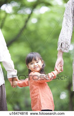 Family holding hands, rear view View Large Photo Image Stock Photograph - Family holding hands, rear view. Fotosearch