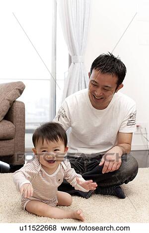Father and Baby Boy Sitting on Living Room Floor View Large Photo Image Stock Photo - Father and Baby Boy Sitting on Living Room Floor. Fotosearch