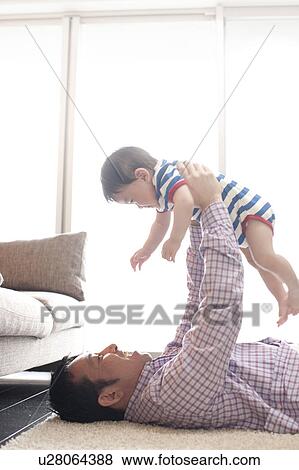 Stock Photo - Father Holding Baby Boy Aloft. Fotosearch