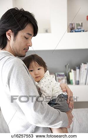 Stock Image - Father Holding Baby Boy. Fotosearch