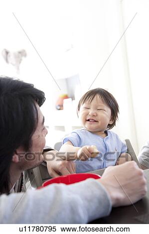 Father Watching Baby Boy to Eat and Grin View Large Photo Image Stock Photography - Father Watching Baby Boy to Eat and Grin. Fotosearch