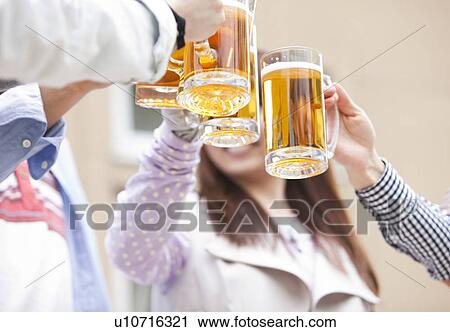 Friends toasting with beer View Large Photo Image Stock Image - Friends toasting with beer. Fotosearch