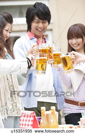 Friends toasting with beer View Large Photo Image Stock Photography - Friends toasting with beer. Fotosearch
